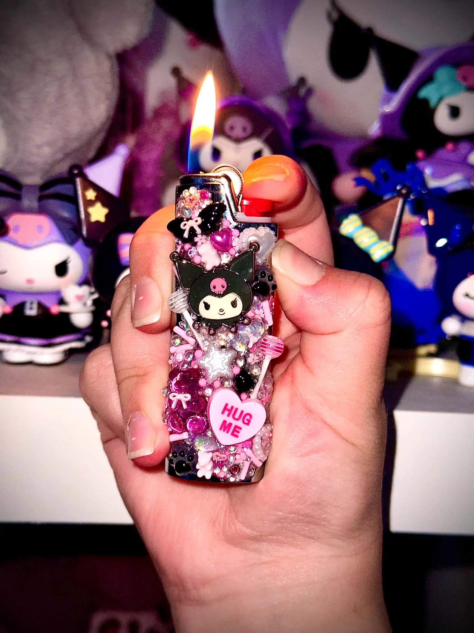 Pink and black handmade lighter accessory with a Kuromi charm and a hug me heart